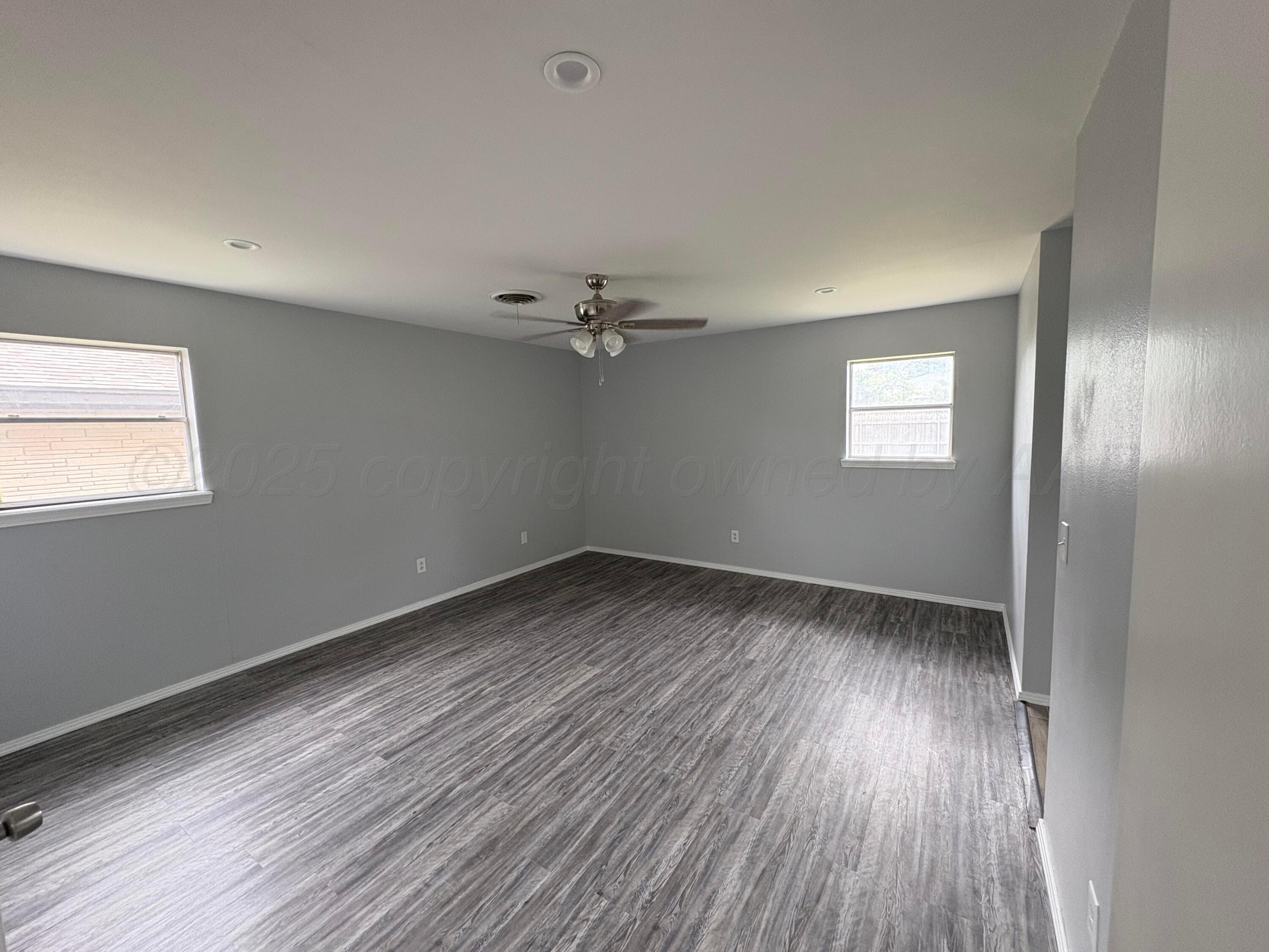 7205 Jameson Road Amarillo, TX 79106 - Photo 6 of 13 wooden floor in an empty room with a window