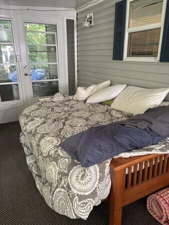 262 Shetucket Turnpike Griswold, CT 06351 - Photo 11 of 24 a bed sitting in a bedroom next to a window
