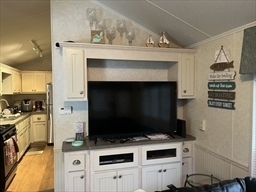 262 Shetucket Turnpike Griswold, CT 06351 - Photo 14 of 24 a living room with furniture a flat screen tv and a fireplace