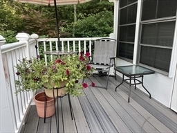 262 Shetucket Turnpike Griswold, CT 06351 - Photo 17 of 24 a balcony with wooden floor table and chairs