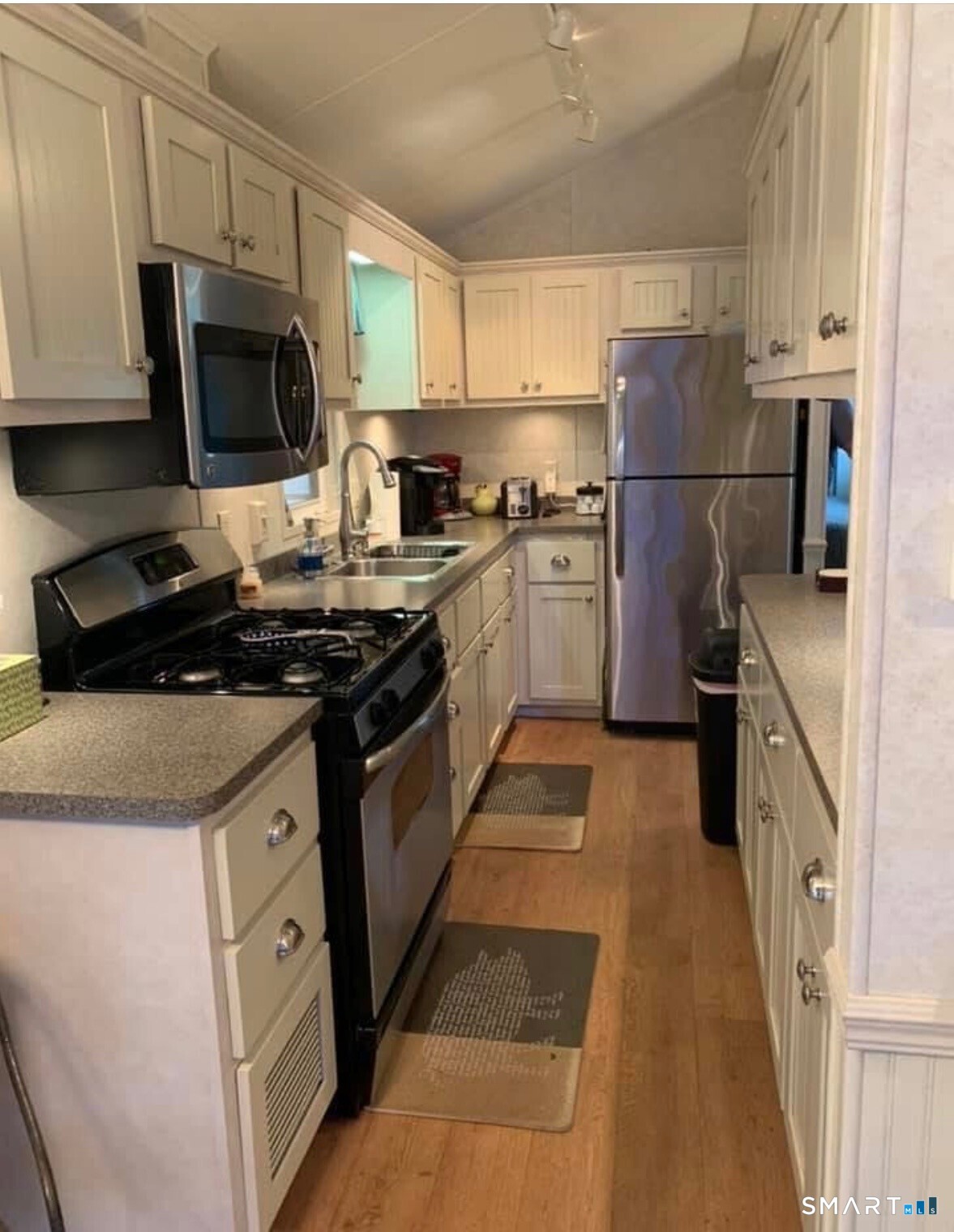 262 Shetucket Turnpike Griswold, CT 06351 - Photo 4 of 24 a kitchen with granite countertop a refrigerator stove and microwave