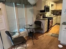 a kitchen with stainless steel appliances kitchen island granite countertop dining table chair and granite counter tops