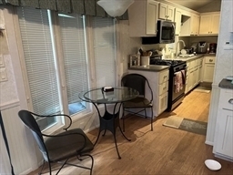 262 Shetucket Turnpike Griswold, CT 06351 - Photo 5 of 24 a kitchen with stainless steel appliances kitchen island granite countertop dining table chair and granite counter tops