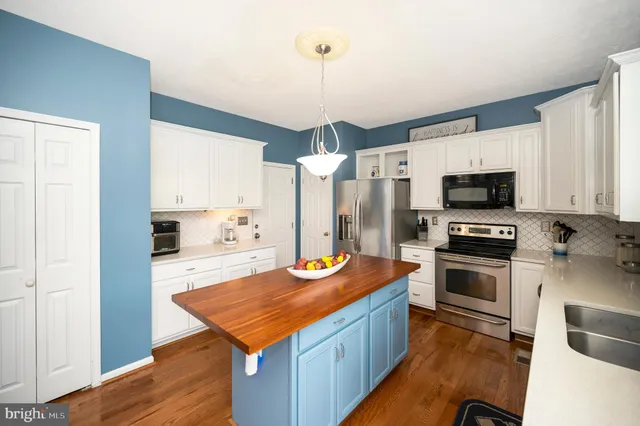 a kitchen that has a lot of cabinets and appliances