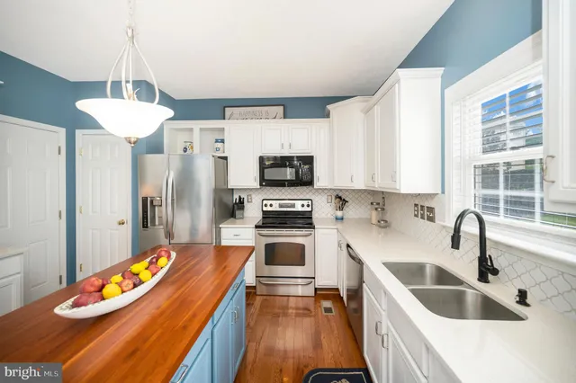 a kitchen with stainless steel appliances a refrigerator stove and sink