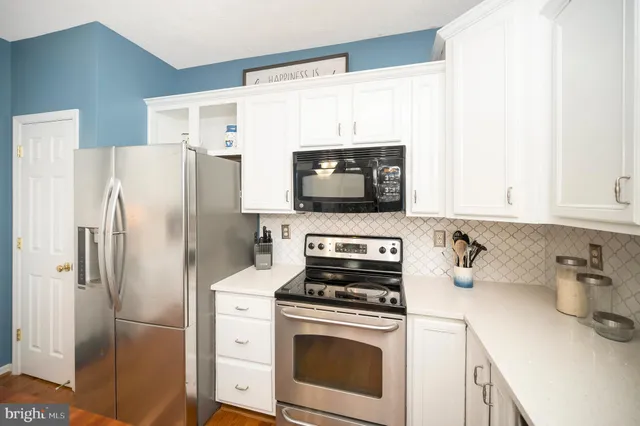 a view of a kitchen with sink and cabinets