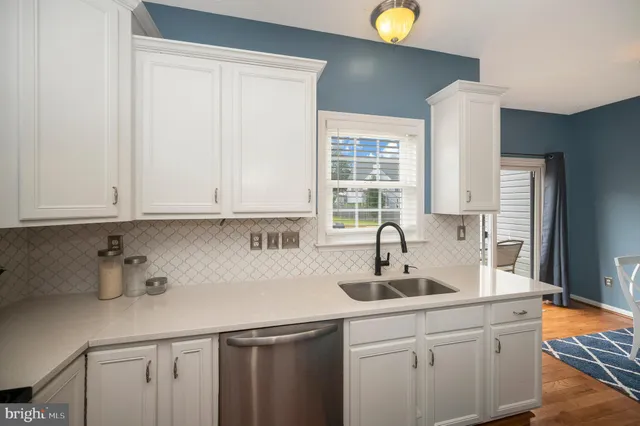 a kitchen with sink a microwave a stove and cabinets