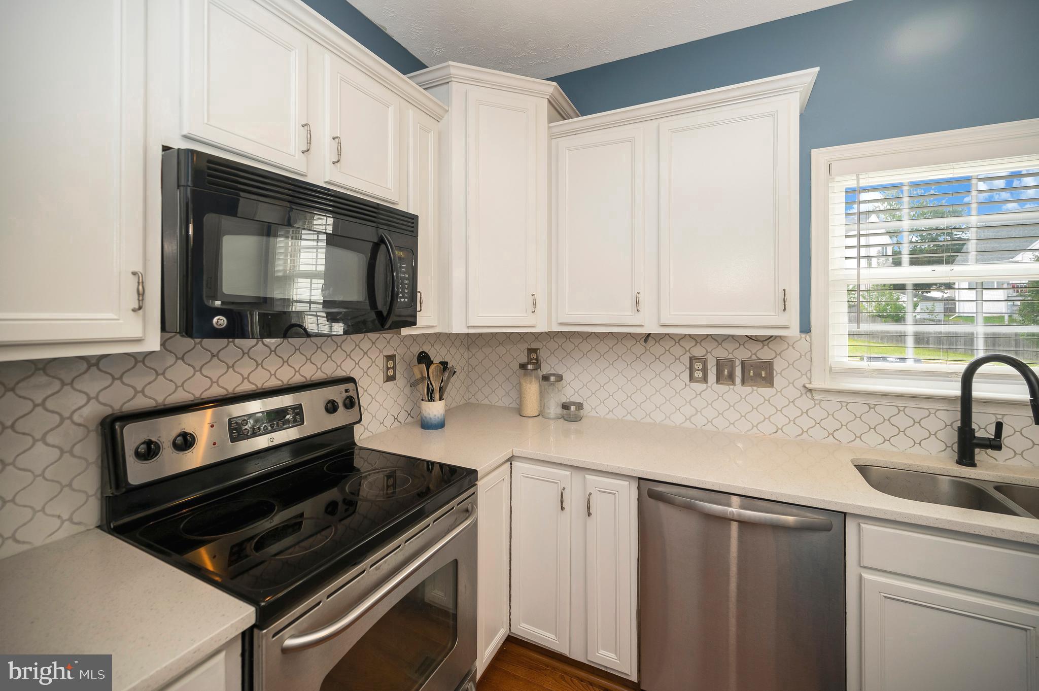 35342 Hawks Nest Court Locust Grove, VA 22508 - Photo 21 of 52 a kitchen with sink a microwave a stove and cabinets