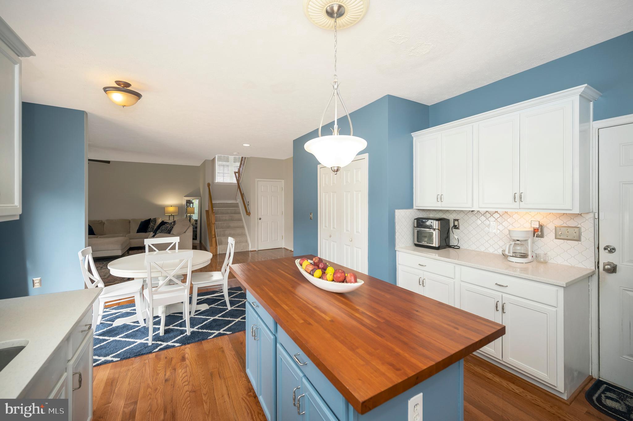 35342 Hawks Nest Court Locust Grove, VA 22508 - Photo 22 of 52 a room with stainless steel appliances kitchen island granite countertop furniture and a view of living room