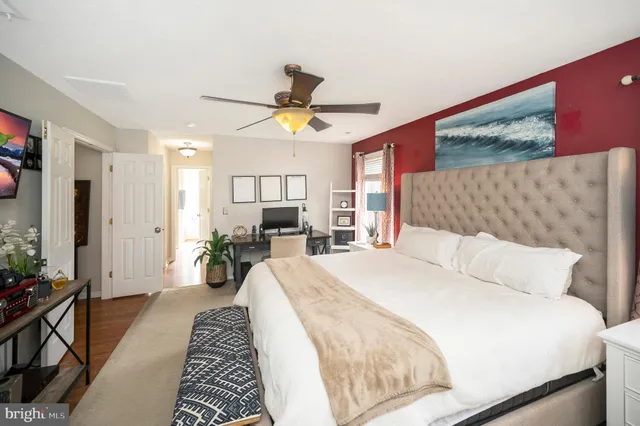 a bathroom with a granite countertop sink a mirror a bathtub and shower