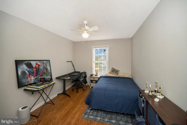 a view of a workspace with furniture and a flat screen tv