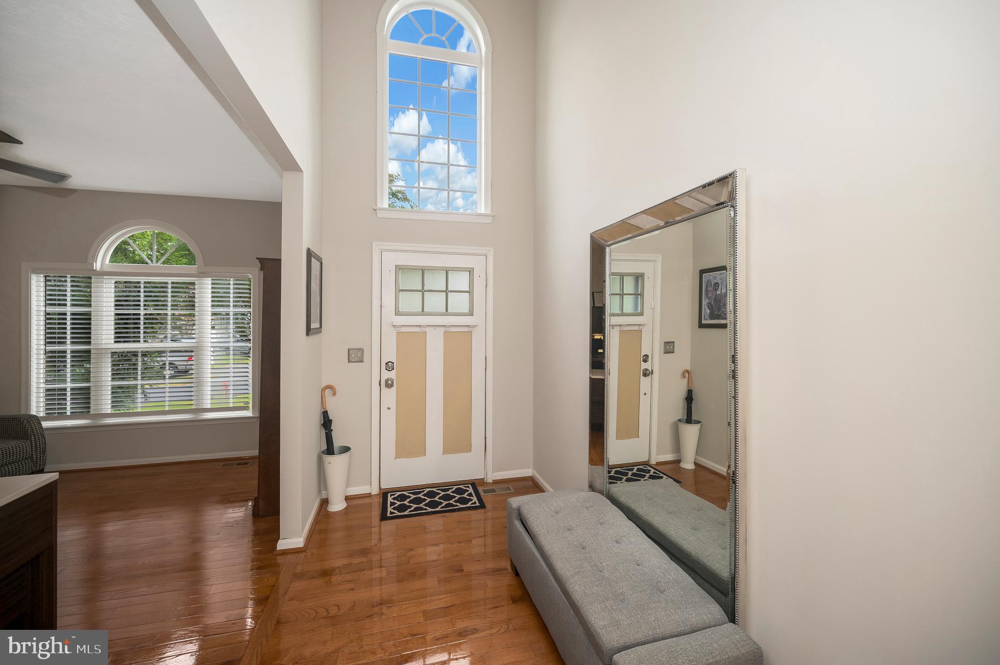 35342 Hawks Nest Court Locust Grove, VA 22508 - Photo 4 of 52 a view of a hallway with wooden floor and a livingroom with furniture