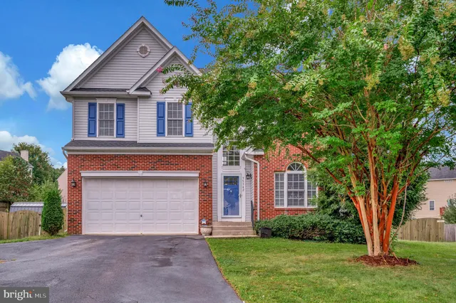 a front view of a house with a garden and yard