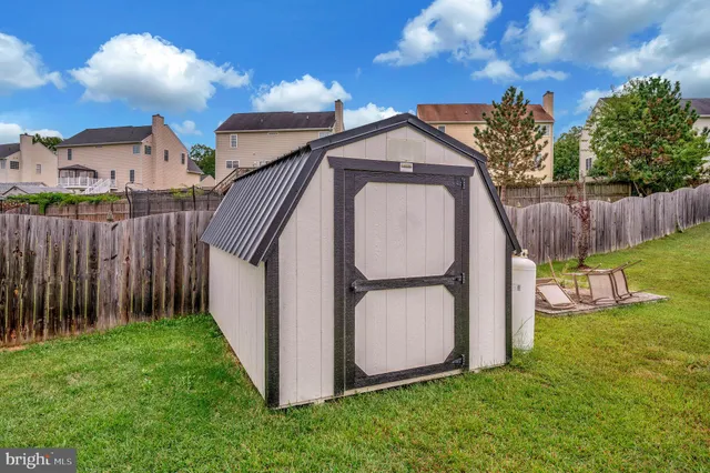 a front view of a house with a garden and plants