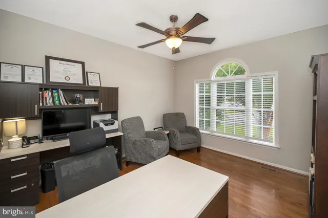 a living room with furniture a window and a flat screen tv