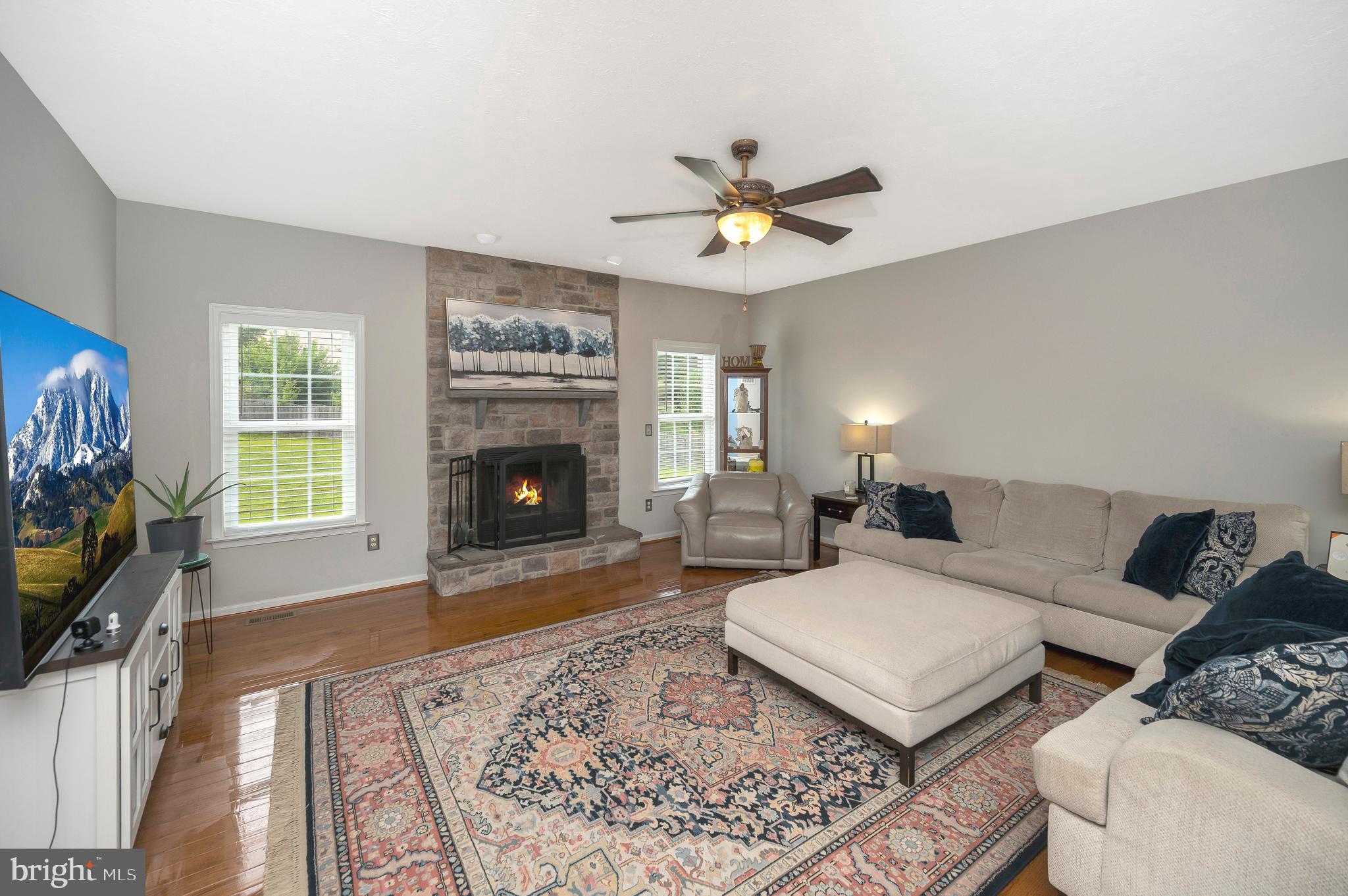 35342 Hawks Nest Court Locust Grove, VA 22508 - Photo 9 of 52 a living room with furniture a fireplace and a flat screen tv