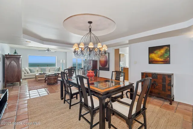 a view of a dining room with furniture and chandelier