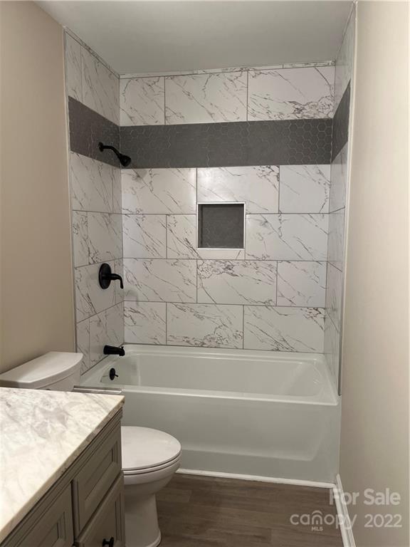 220 Pine Road Mount Holly, NC 28120 - Photo 11 of 20 a bathroom with a granite countertop bathtub sink vanity mirror and toilet