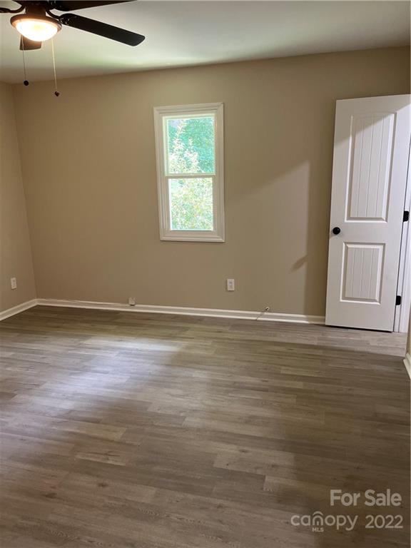 220 Pine Road Mount Holly, NC 28120 - Photo 14 of 20 a view of a room with wooden floor and cabinet