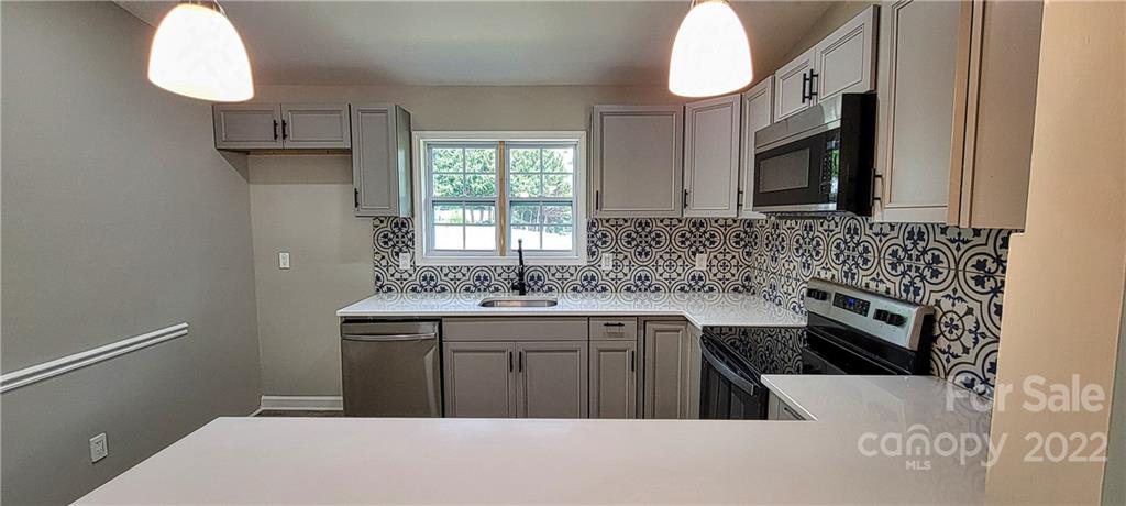 220 Pine Road Mount Holly, NC 28120 - Photo 5 of 20 a kitchen with a sink cabinets and window