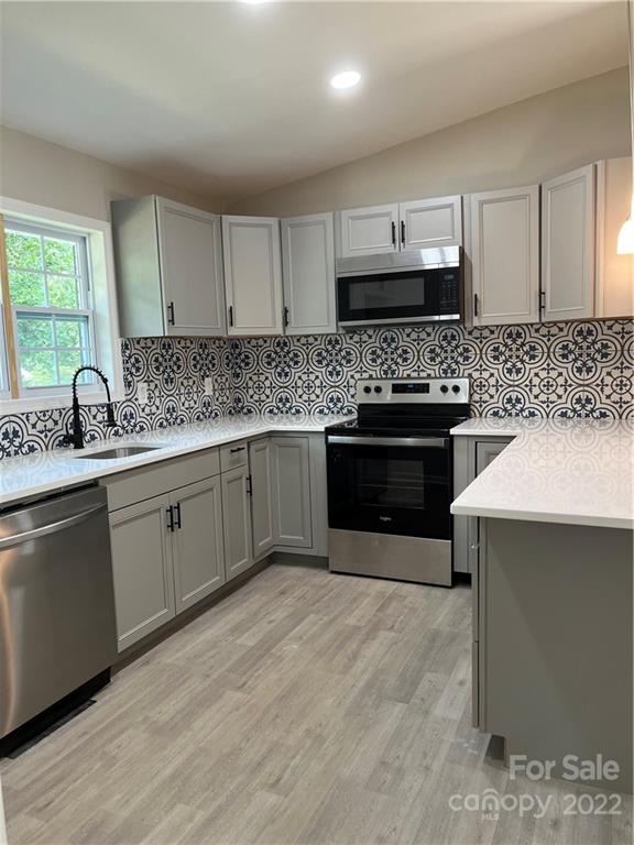 220 Pine Road Mount Holly, NC 28120 - Photo 6 of 20 a kitchen with stainless steel appliances a sink stove and cabinets