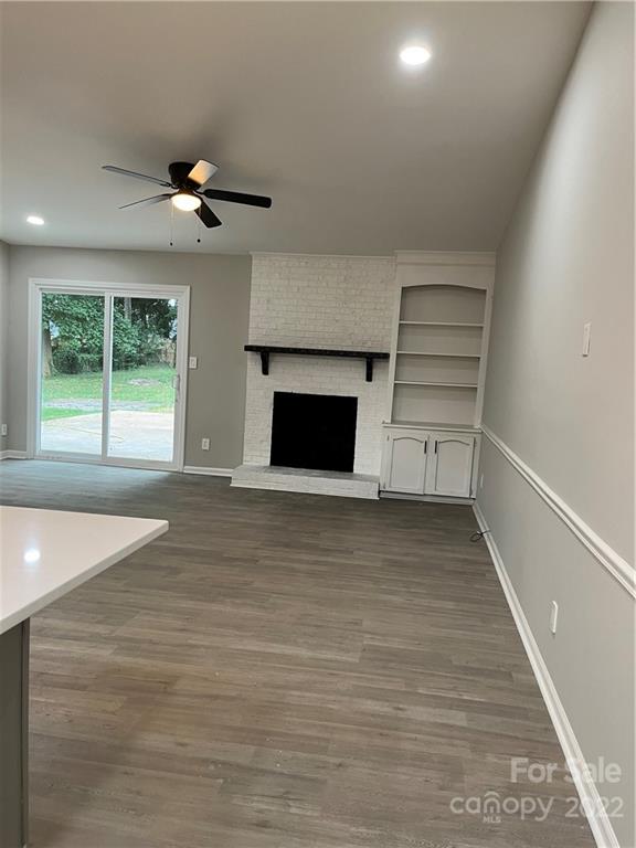 220 Pine Road Mount Holly, NC 28120 - Photo 7 of 20 an empty room with windows and a fireplace