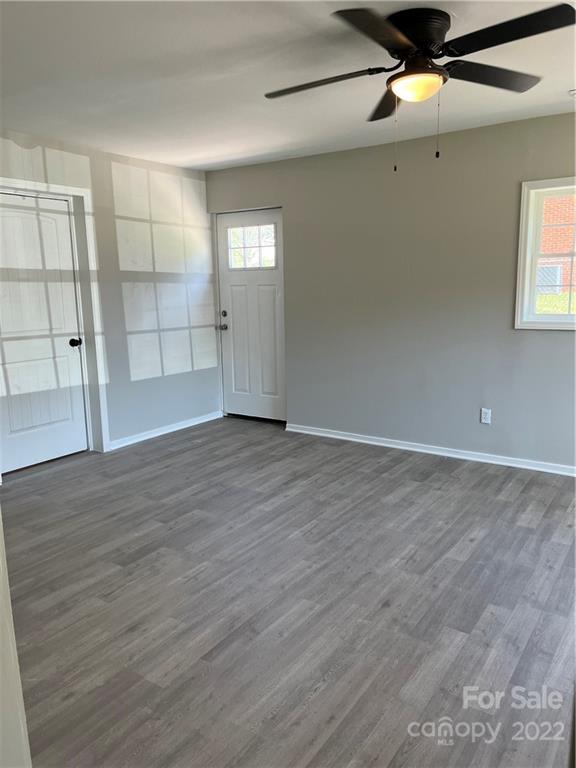 220 Pine Road Mount Holly, NC 28120 - Photo 8 of 20 an empty room with wooden floor and windows