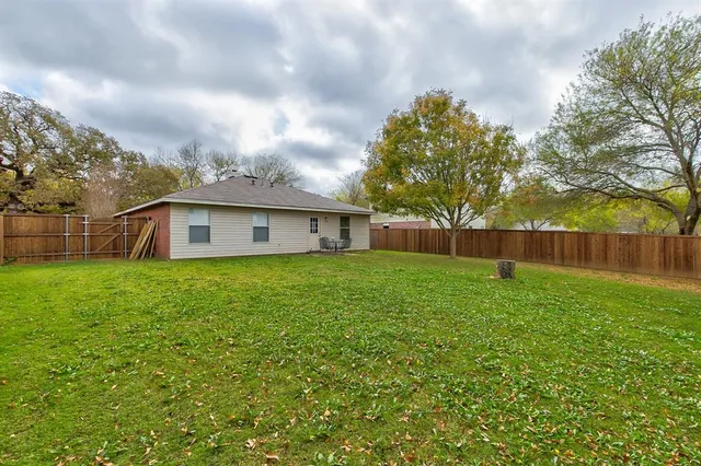 a front view of house with a garden