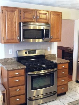 36 Blackbird Road Barnstable, MA 02648 - Photo 5 of 29 a stove top oven sitting inside of a kitchen and granite counter tops