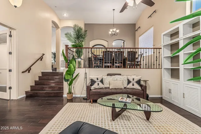 a view of a dining room with furniture a chandelier and wooden floor