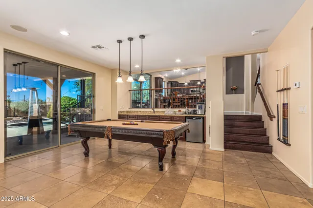 a dining room with furniture a chandelier and wooden floor