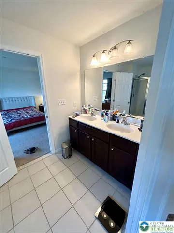 a bathroom with a sink vanity and mirror