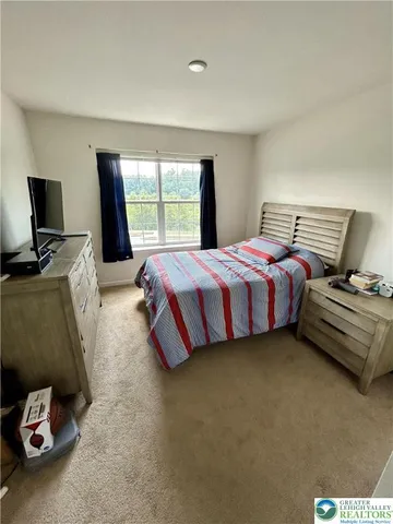 a bedroom with a bed and flat screen tv