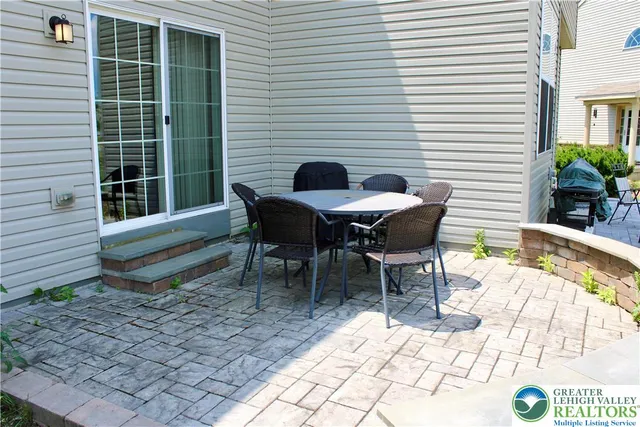 a view of a lounge chairs in back yard of the house