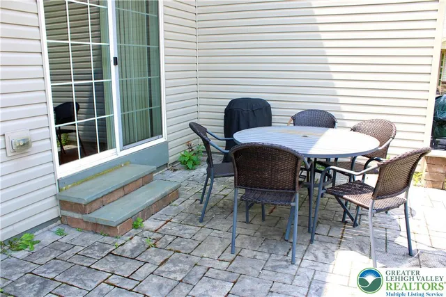 a view of a chairs and table in the back