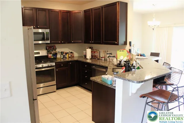 a kitchen with a sink and a stove top oven with wooden floor