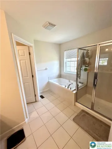 a bathroom with a tub and a shower