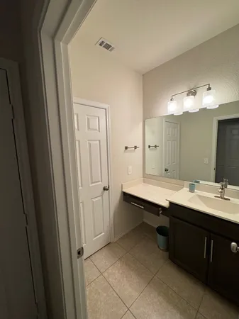 a bathroom with a double vanity sink and mirror
