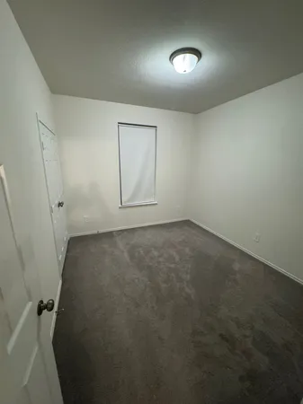 an empty room with a space and windows