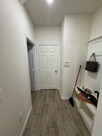 a view of a room with wooden floor