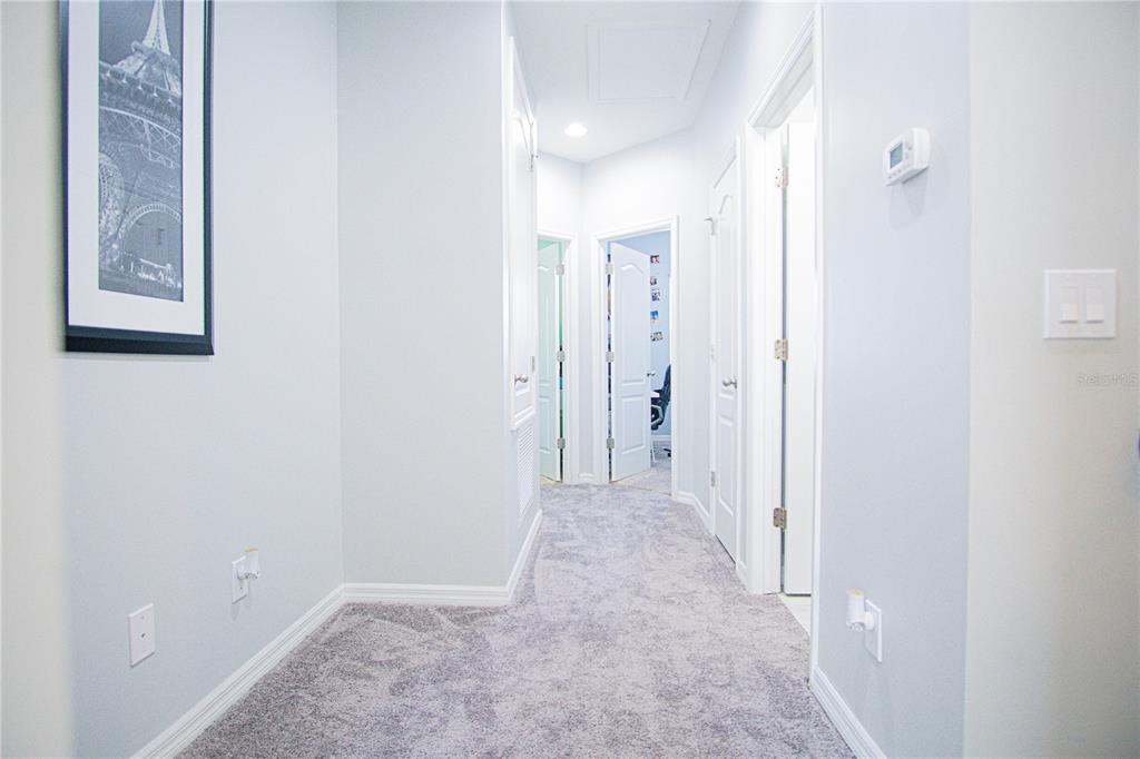 11636 Water Run Alley Windermere, FL 34786 - Photo 9 of 18 a view of a hallway with wooden shelves