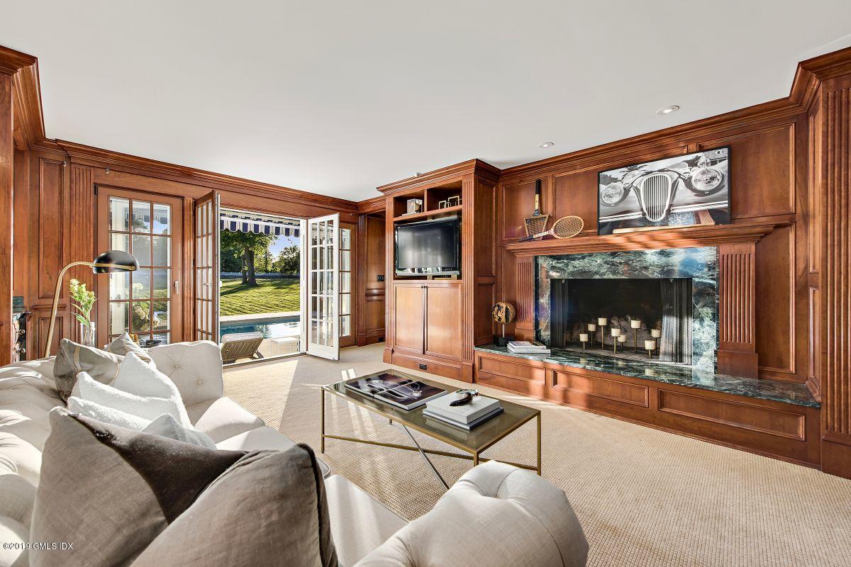 578 Riversville Road Greenwich, CT 06831 - Photo 13 of 38 a living room with furniture a large window and a fireplace