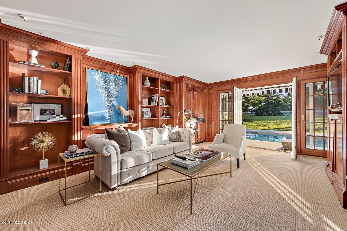 578 Riversville Road Greenwich, CT 06831 - Photo 14 of 38 a living room with furniture and a floor to ceiling window