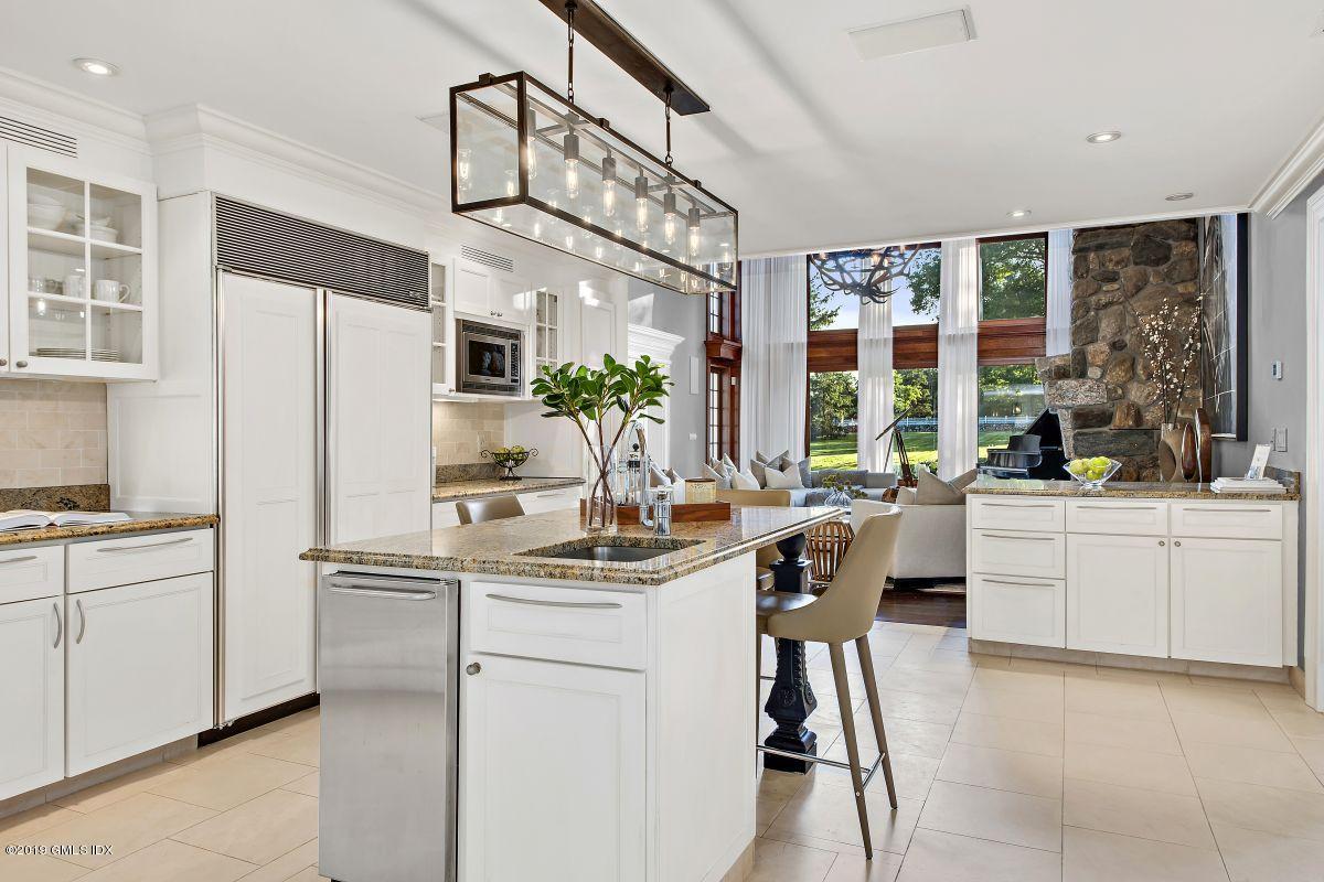 578 Riversville Road Greenwich, CT 06831 - Photo 18 of 38 a kitchen with white cabinets and white appliances
