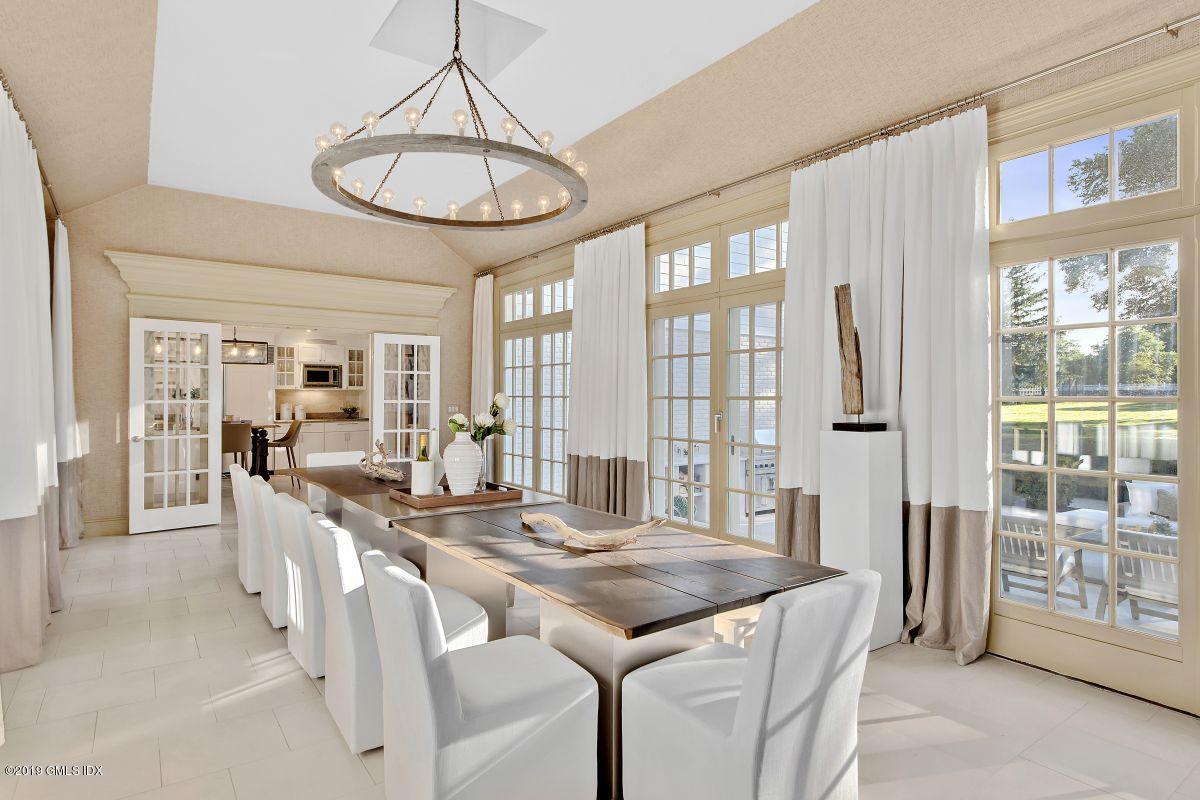 578 Riversville Road Greenwich, CT 06831 - Photo 21 of 38 a view of a dining room with furniture large windows and wooden floor