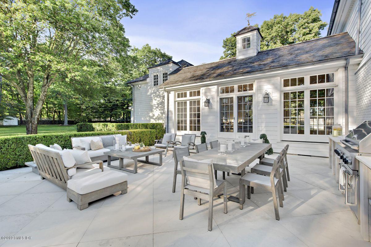 578 Riversville Road Greenwich, CT 06831 - Photo 22 of 38 a view of a patio with couches chairs and a big yard