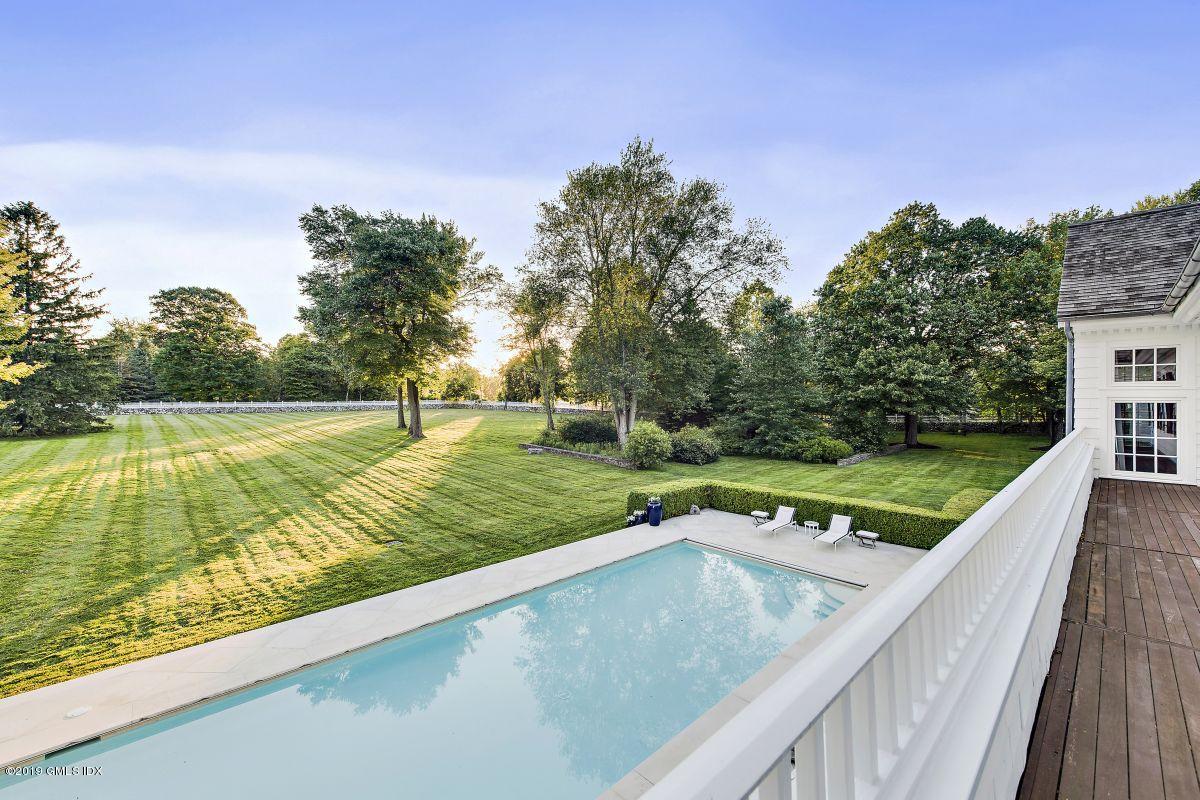 578 Riversville Road Greenwich, CT 06831 - Photo 27 of 38 a view of a swimming pool with a yard