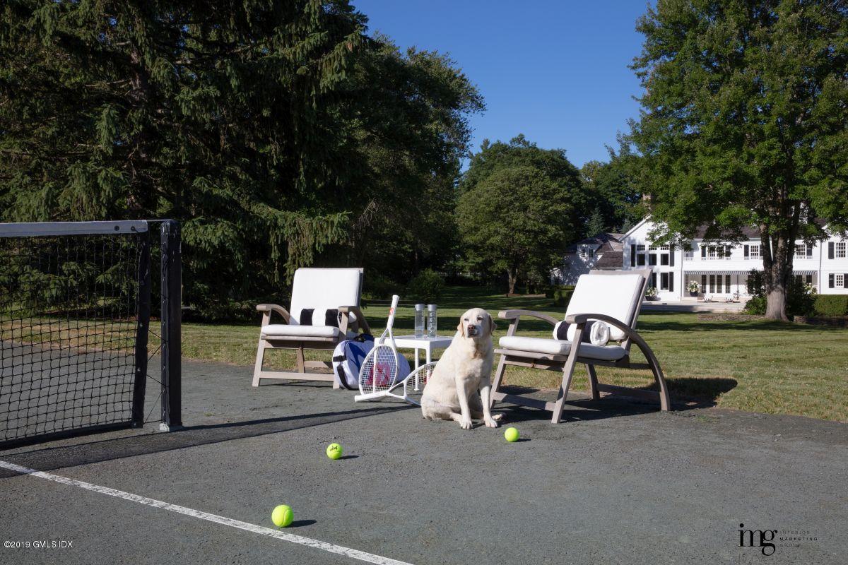 578 Riversville Road Greenwich, CT 06831 - Photo 36 of 38 a view of a patio with table and chairs with wooden fence and plants
