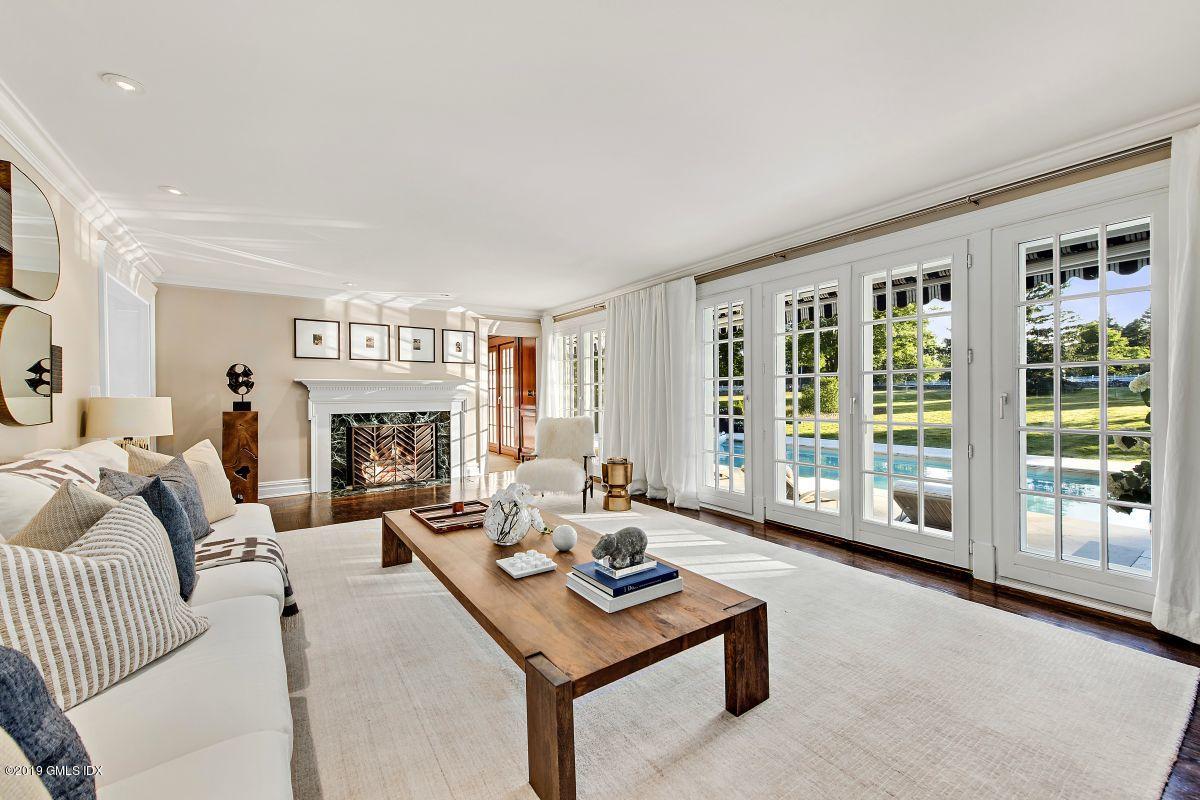 578 Riversville Road Greenwich, CT 06831 - Photo 9 of 38 a living room with furniture large window and a fireplace