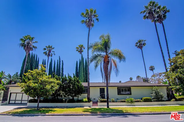 a front view of a house with swimming pool having outdoor seating